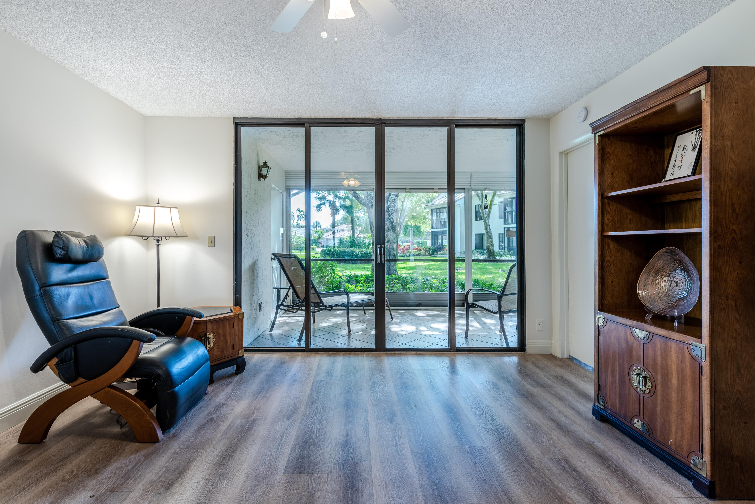 7527 Glendevon Lane, Unit 803 Delray Beach, FL 33446 - Photo 14 of 35 a living room with furniture and a wooden floor