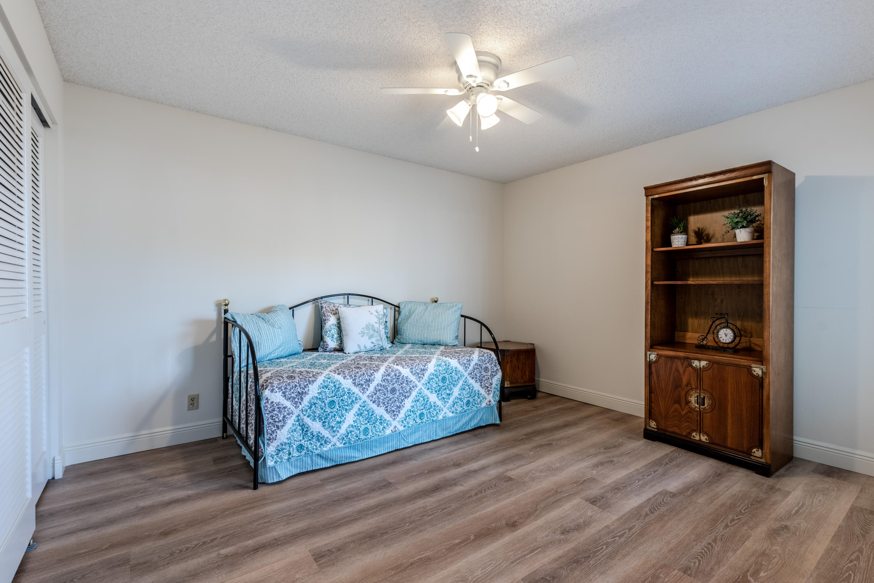 7527 Glendevon Lane, Unit 803 Delray Beach, FL 33446 - Photo 26 of 35 a spacious bedroom with a bed and a chandelier