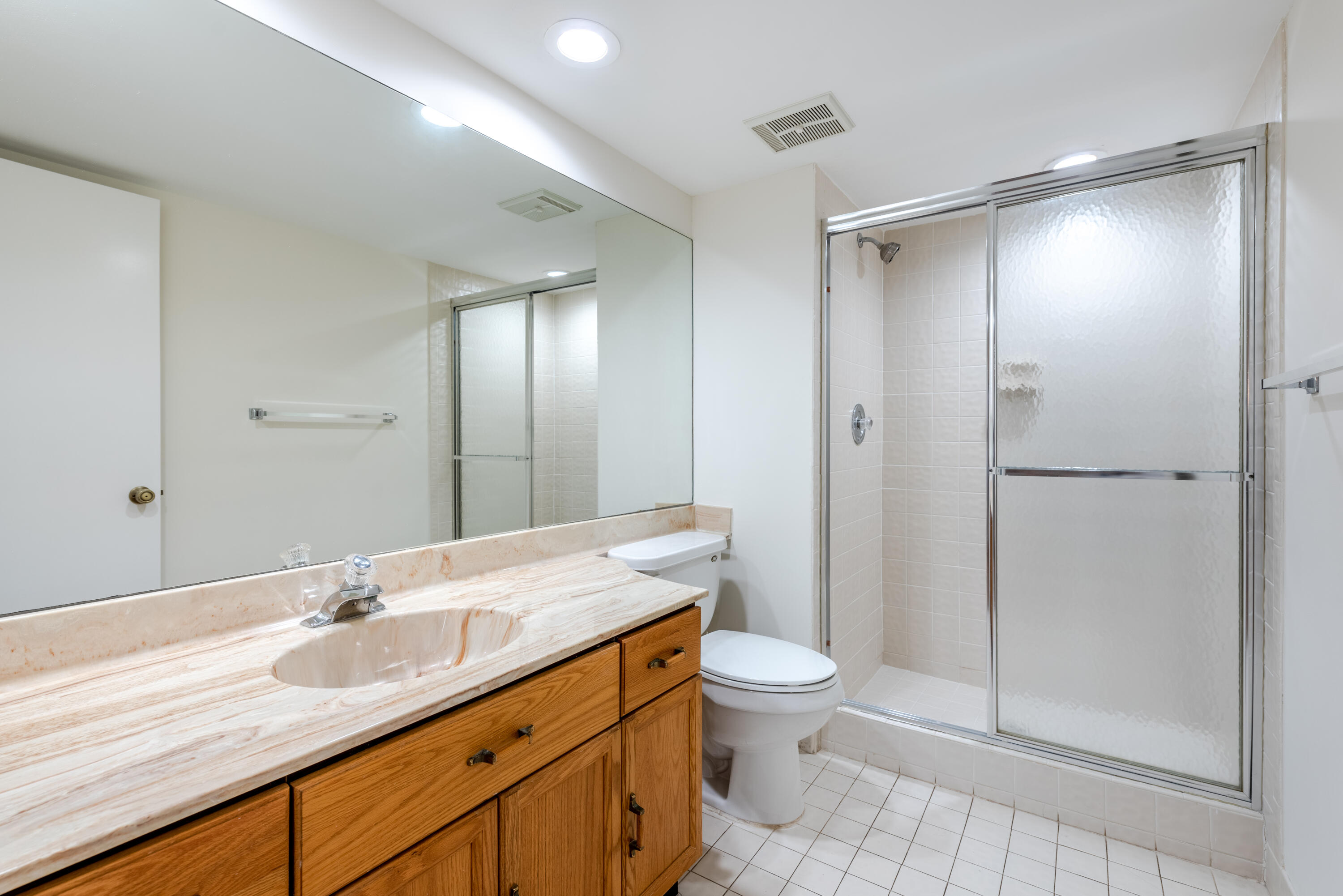 7527 Glendevon Lane, Unit 803 Delray Beach, FL 33446 - Photo 29 of 35 a bathroom with a granite countertop sink toilet and shower