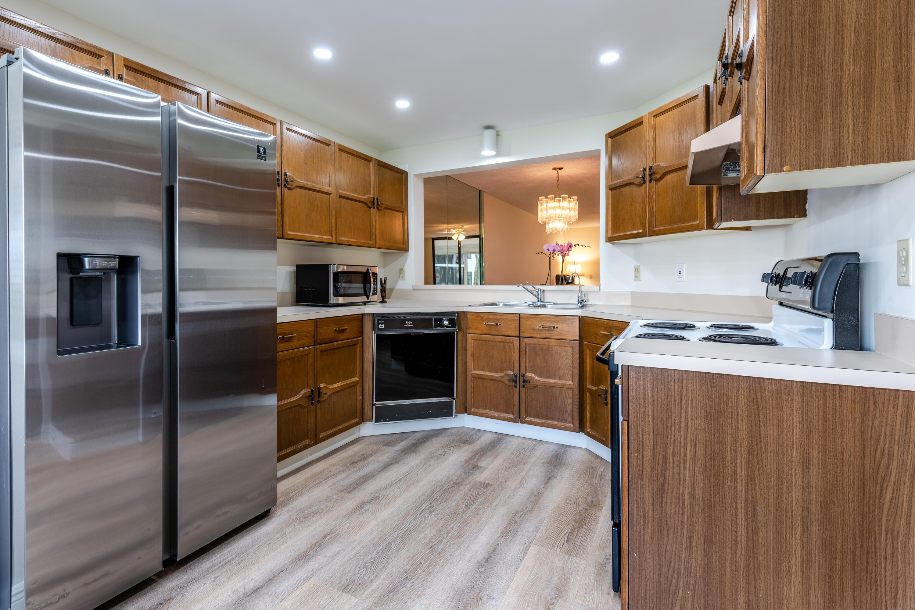 7527 Glendevon Lane, Unit 803 Delray Beach, FL 33446 - Photo 5 of 35 a kitchen with stainless steel appliances granite countertop a stove a sink and a refrigerator
