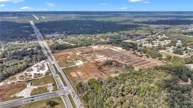 a view of a dry yard with wooden floor and city view