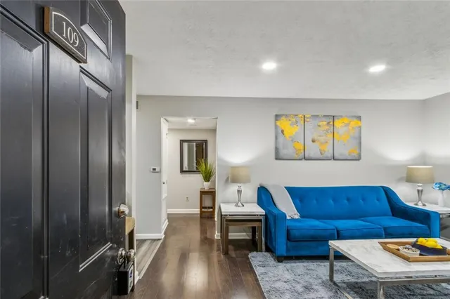 a living room with furniture and a wooden floor