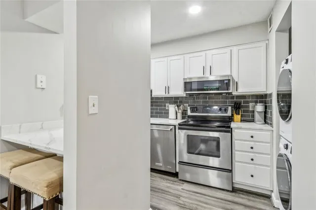 a kitchen with stainless steel appliances granite countertop a stove and a refrigerator