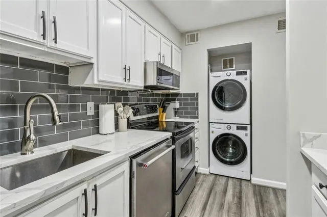 a view of a kitchen with sink washer and dryer