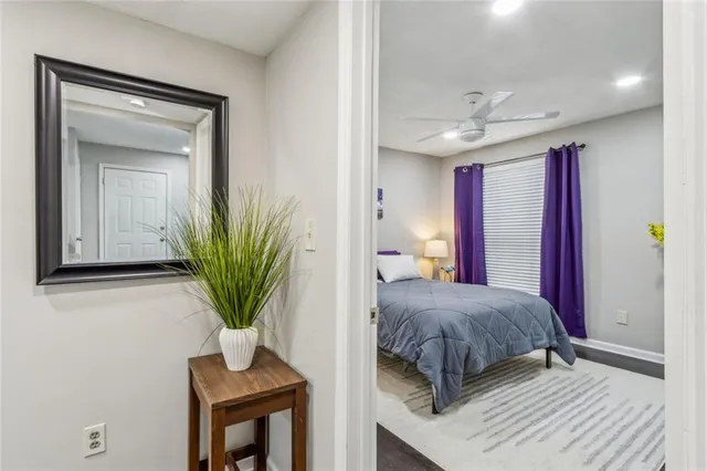 a bedroom with a bed and a potted plant