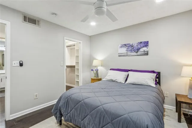 a bed sitting in a bedroom next to a bathroom