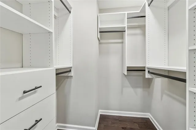 a view of walk in closet with empty racks