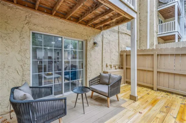 a outdoor living space with furniture and a rug