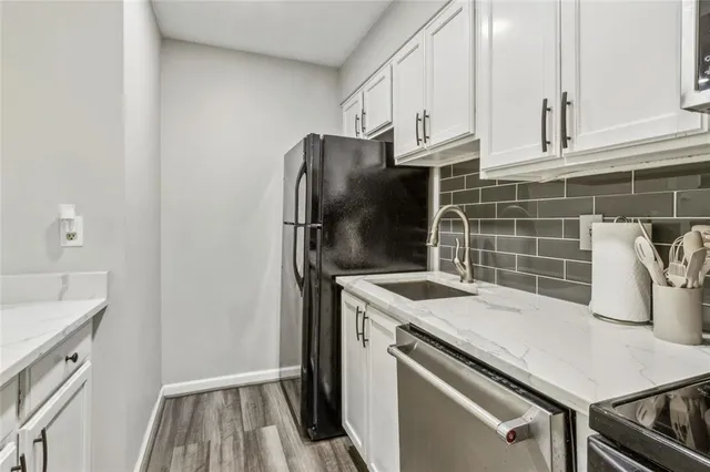 a kitchen with a sink a stove and refrigerator