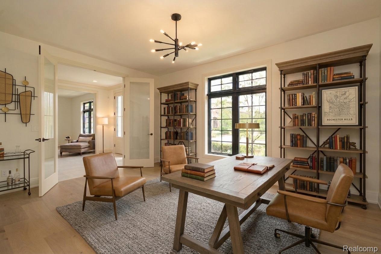3836 Coachwood Lane Rochester, MI 48309 - Photo 17 of 82 Dedicated room featuring wood-finish flooring, a contemporary chandelier, built-in shelving, large black-framed windows, and French doors with frosted glass panels