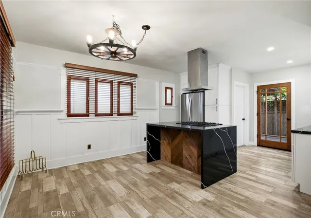 a view of wooden floor and chandelier in a room