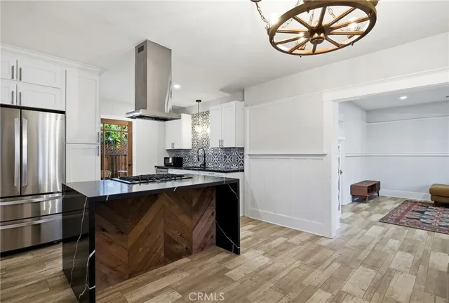 a kitchen with stainless steel appliances granite countertop a refrigerator a stove a sink and a refrigerator