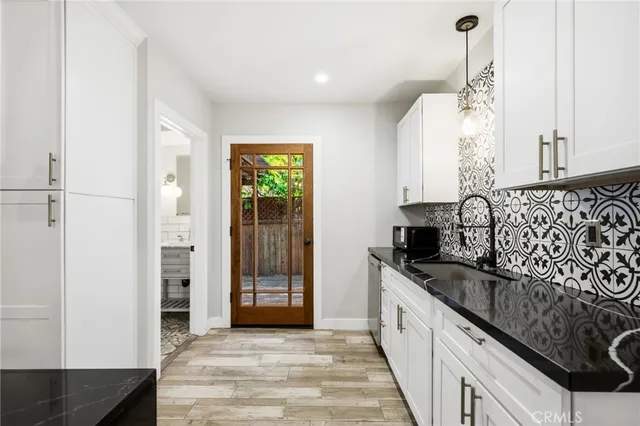 a kitchen with granite countertop a sink and a stove