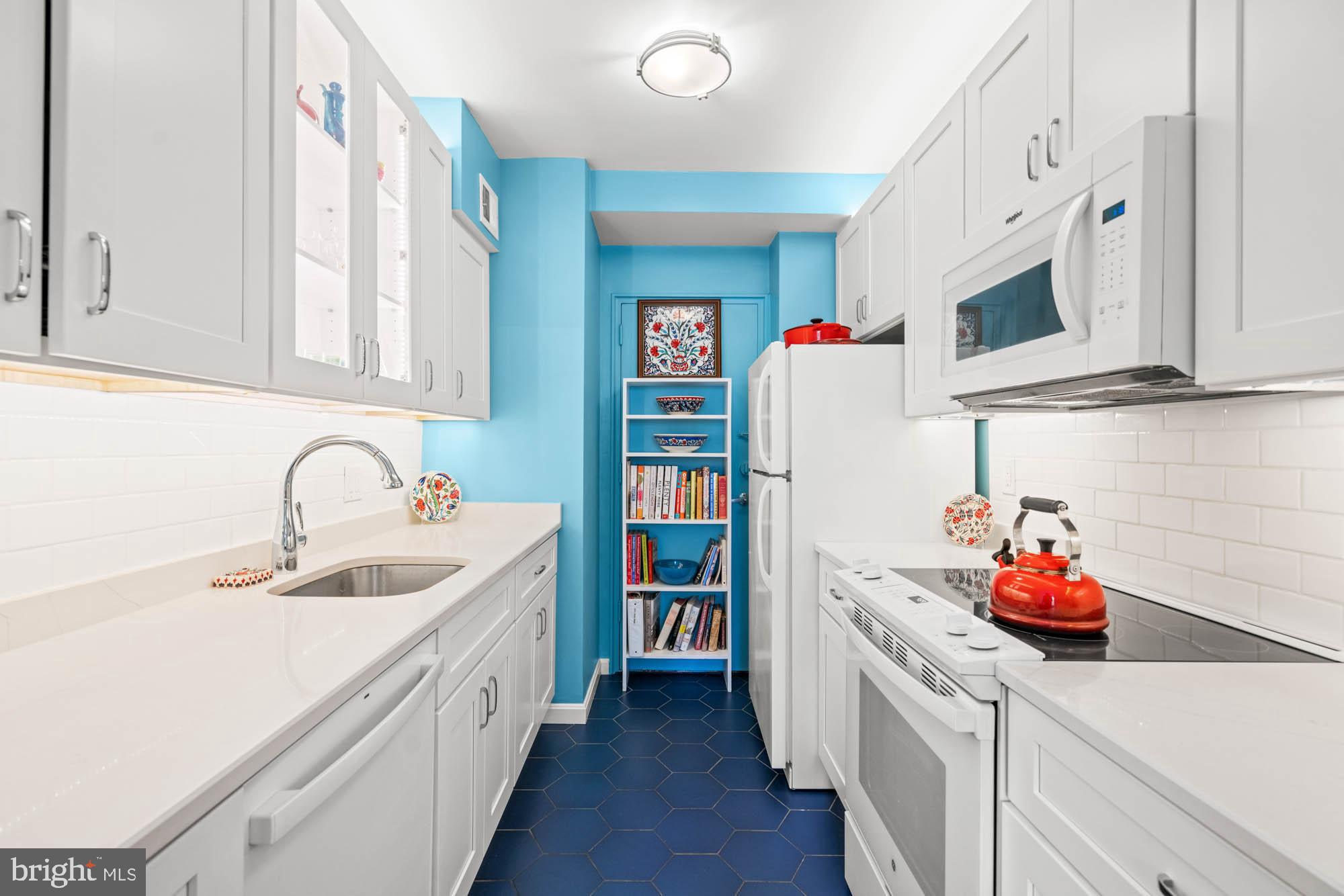 4740 Connecticut Avenue Northwest, Unit 204 Washington, DC 20008 - Photo 11 of 33 a kitchen with cabinets a sink and white appliances