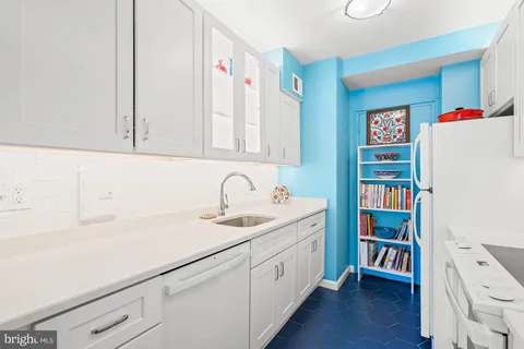 a kitchen with a sink cabinets and wooden floor