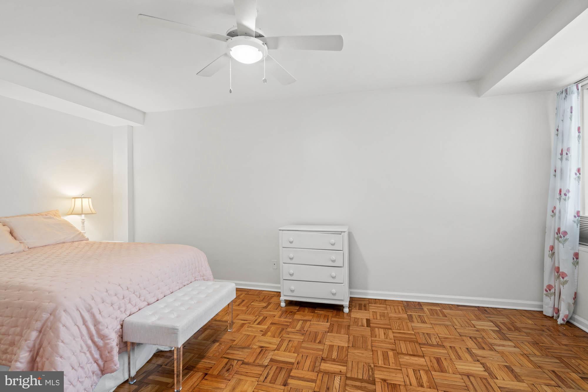 4740 Connecticut Avenue Northwest, Unit 204 Washington, DC 20008 - Photo 18 of 33 a bedroom with a bed and a window