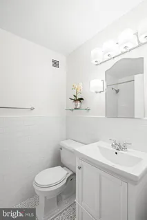 a bathroom with a sink a toilet and mirror