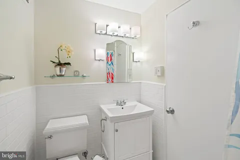 a bathroom with a sink vanity and mirror