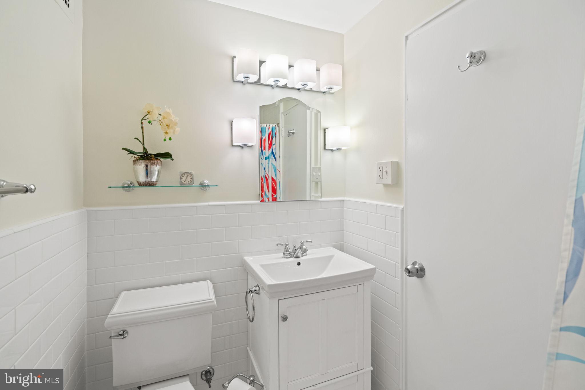 4740 Connecticut Avenue Northwest, Unit 204 Washington, DC 20008 - Photo 24 of 33 a bathroom with a sink vanity and mirror