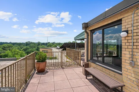 a balcony with view of car parked