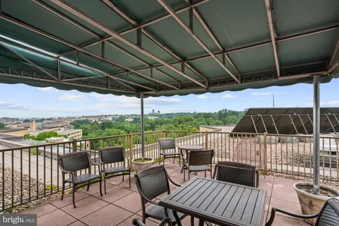 a view of a chairs and table in patio