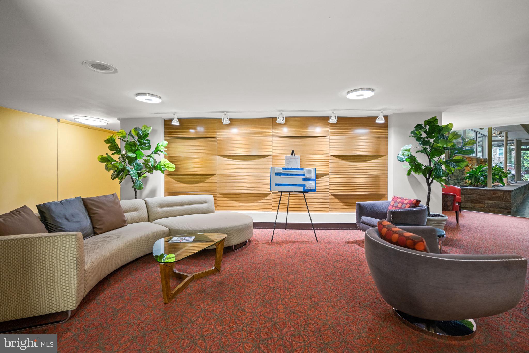 4740 Connecticut Avenue Northwest, Unit 204 Washington, DC 20008 - Photo 33 of 33 a living room with furniture and a potted plant