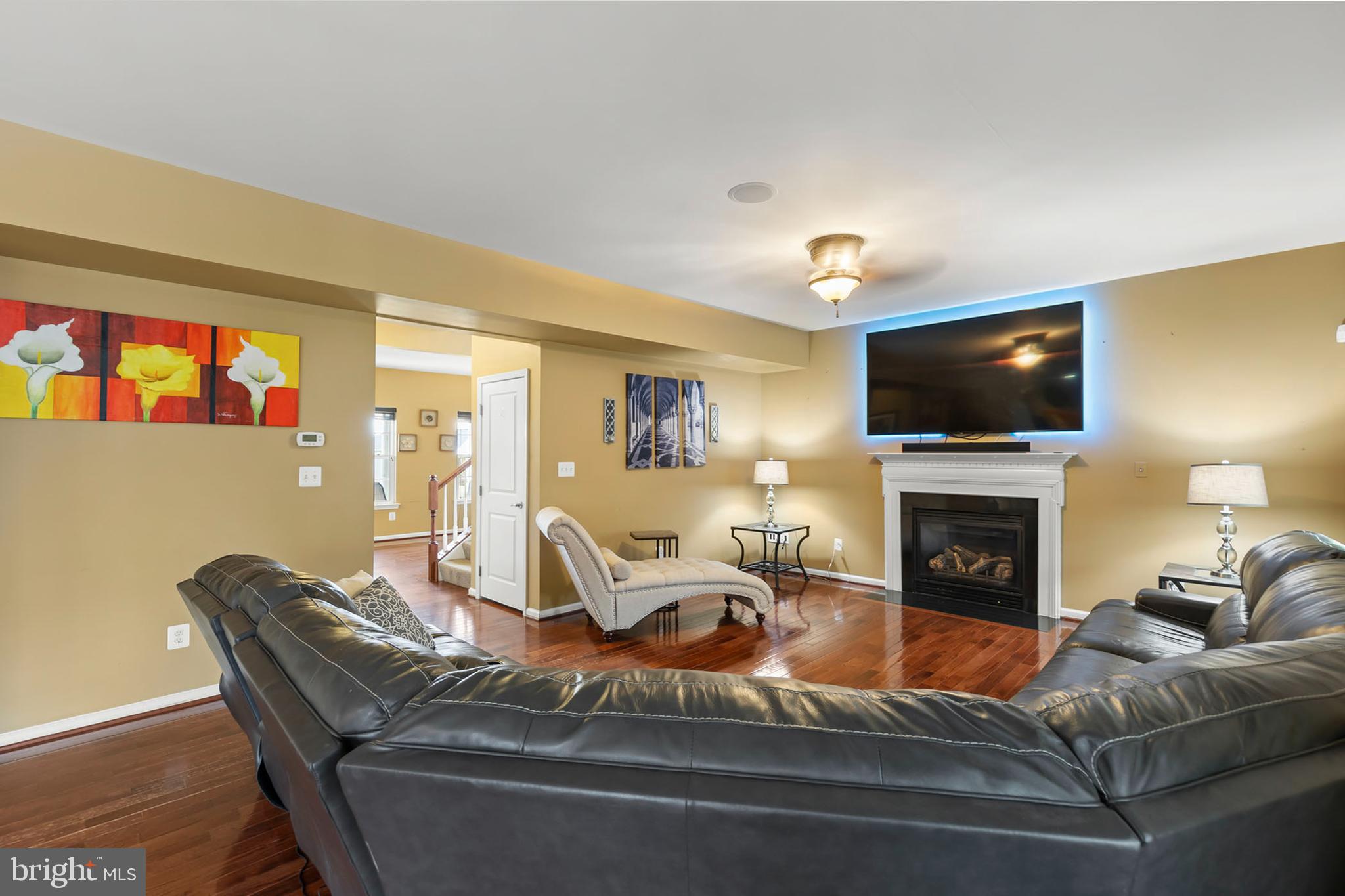 155 Merlot Drive Stephenson, VA 22656 - Photo 14 of 69 a living room with furniture a fireplace and a flat screen tv