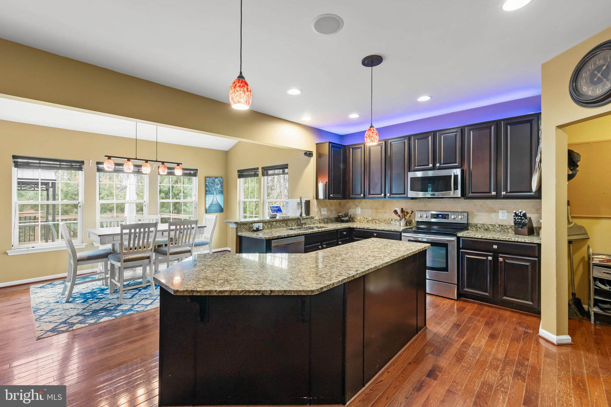 155 Merlot Drive Stephenson, VA 22656 - Photo 16 of 69 a kitchen with kitchen island granite countertop a sink stove and wooden floor