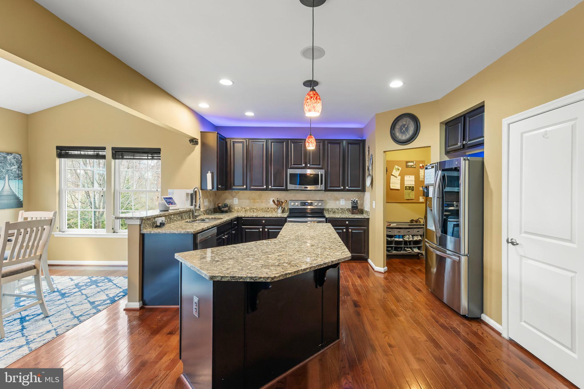 155 Merlot Drive Stephenson, VA 22656 - Photo 17 of 69 a kitchen with stainless steel appliances granite countertop sink stove refrigerator and wooden floor
