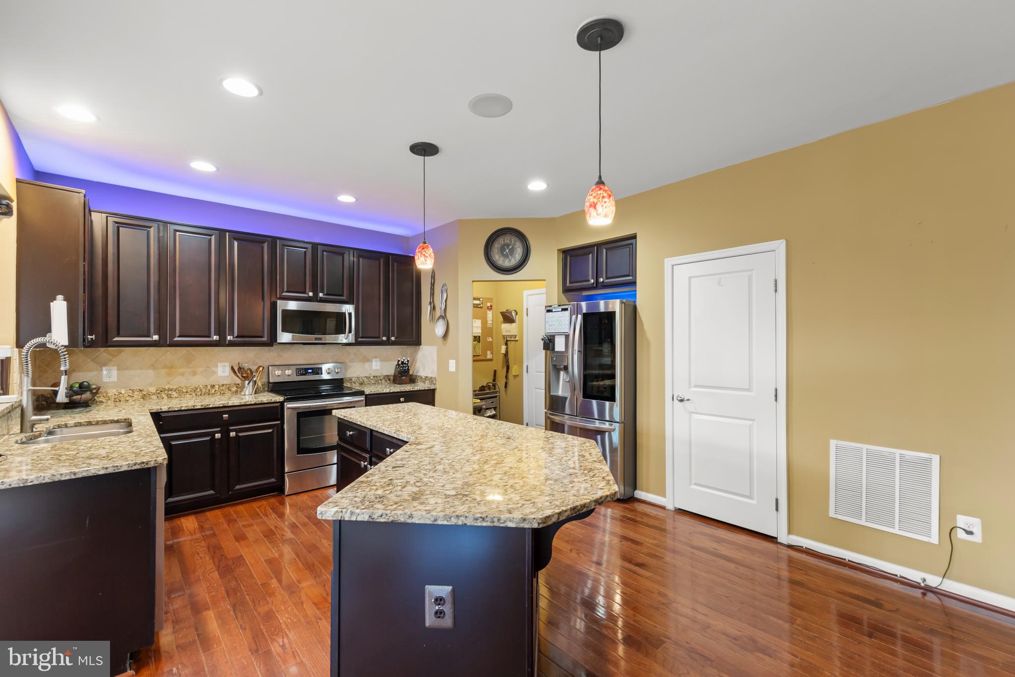 155 Merlot Drive Stephenson, VA 22656 - Photo 20 of 69 a kitchen with granite countertop stainless steel appliances and wooden cabinets