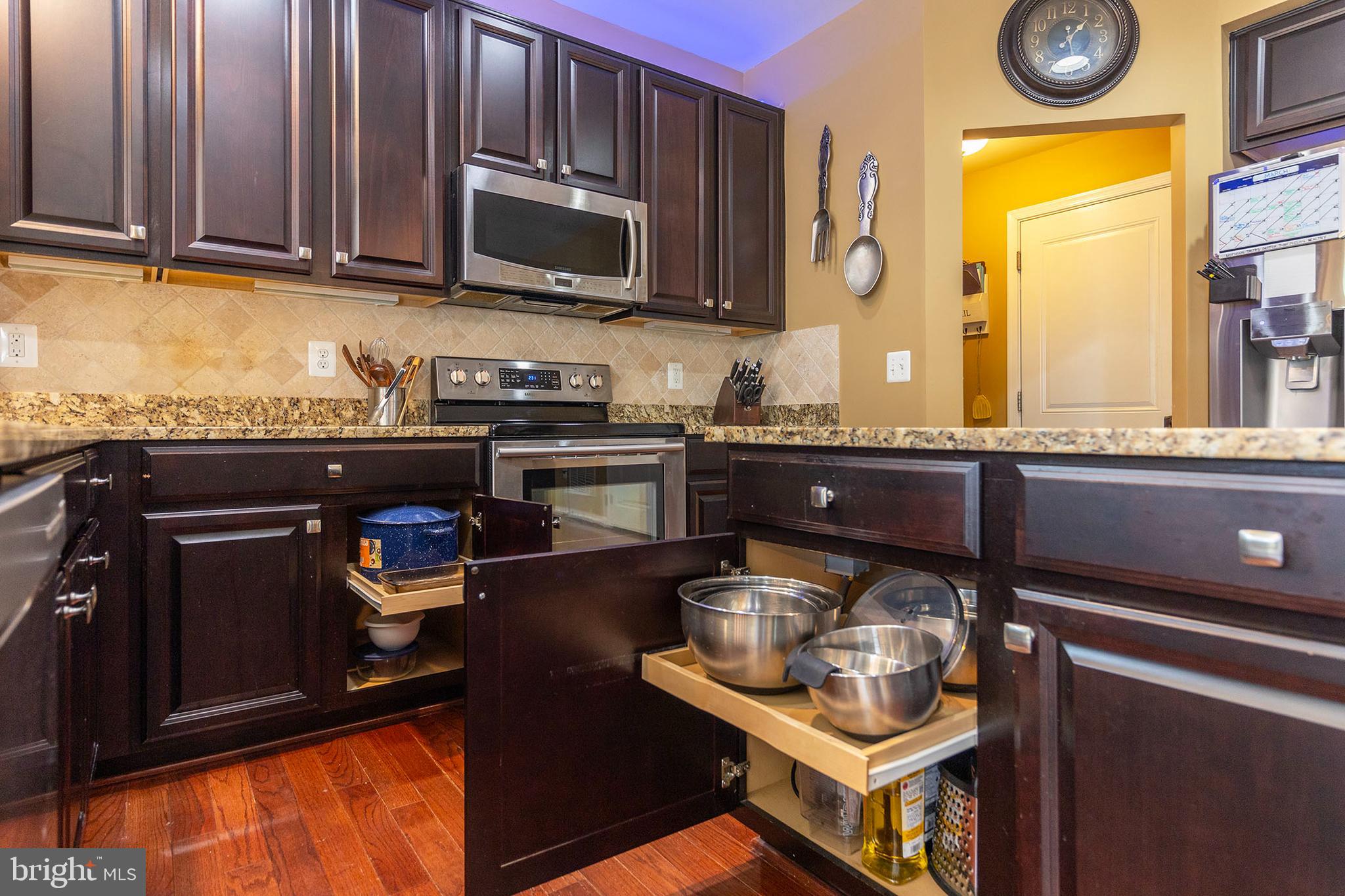 155 Merlot Drive Stephenson, VA 22656 - Photo 24 of 69 a kitchen with granite countertop wooden cabinets and a stove top oven