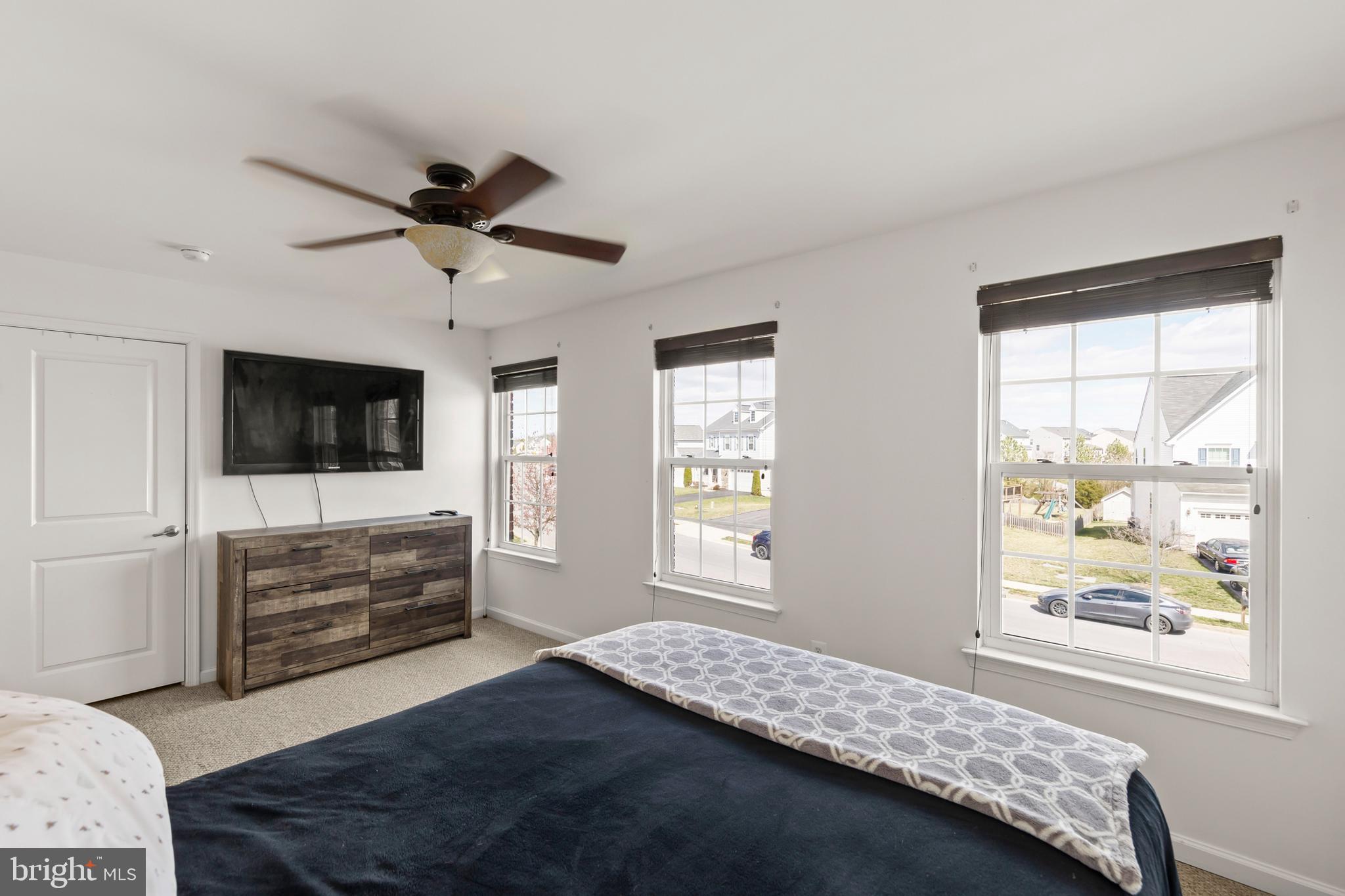 155 Merlot Drive Stephenson, VA 22656 - Photo 30 of 69 a bedroom with a bed and a flat screen tv