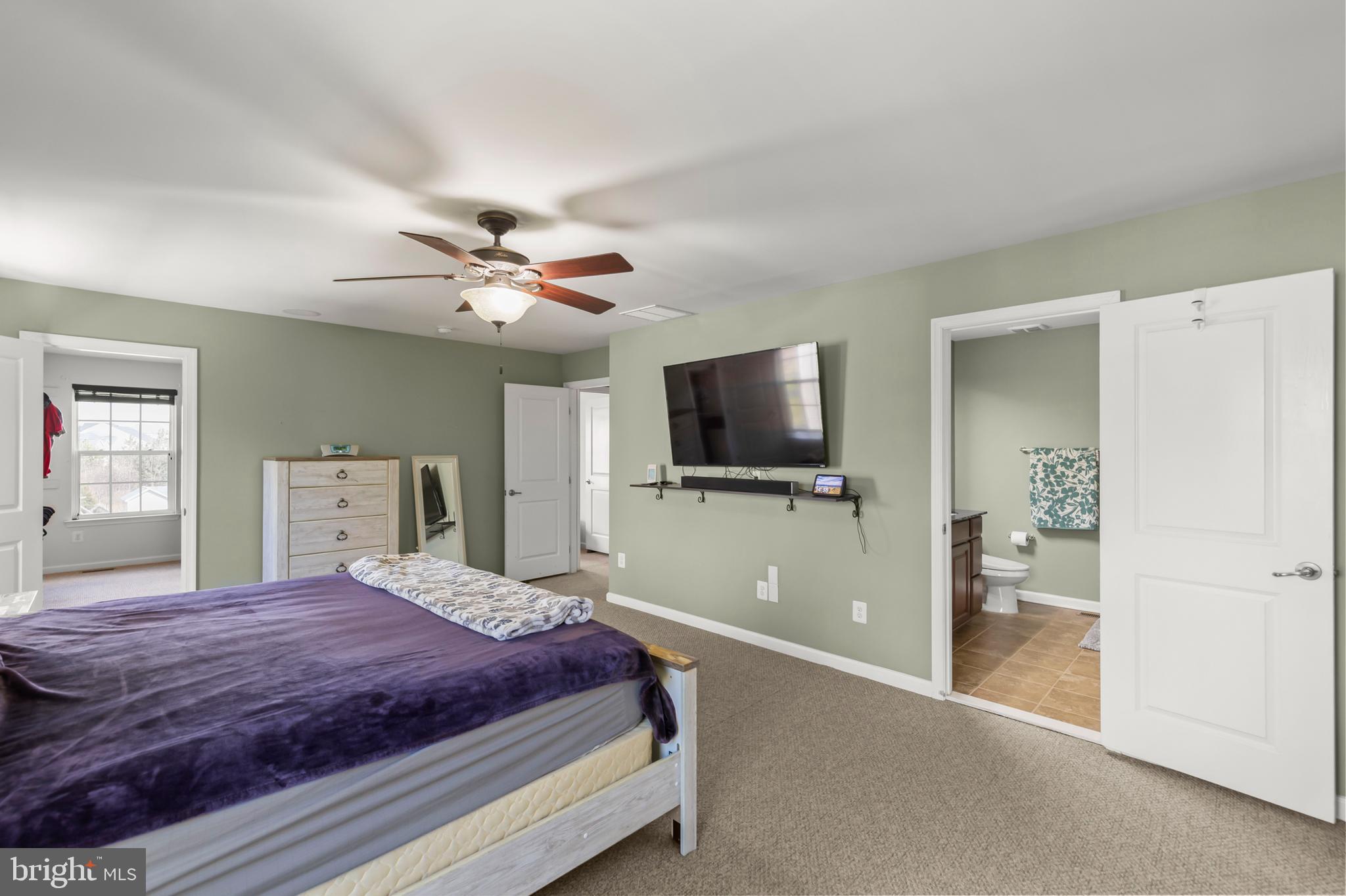 155 Merlot Drive Stephenson, VA 22656 - Photo 33 of 69 a bedroom with a bed and a flat screen tv