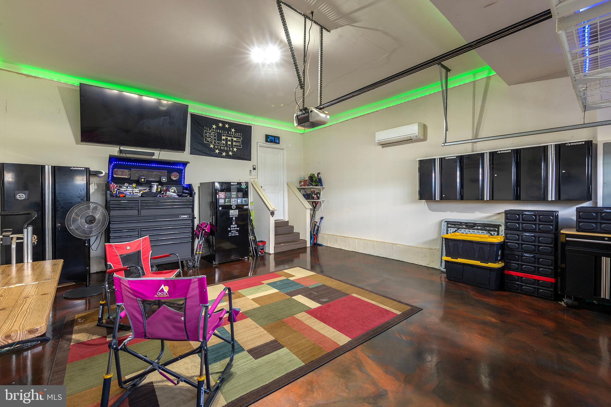 155 Merlot Drive Stephenson, VA 22656 - Photo 52 of 69 a living room with furniture a flat screen tv and gym equipment