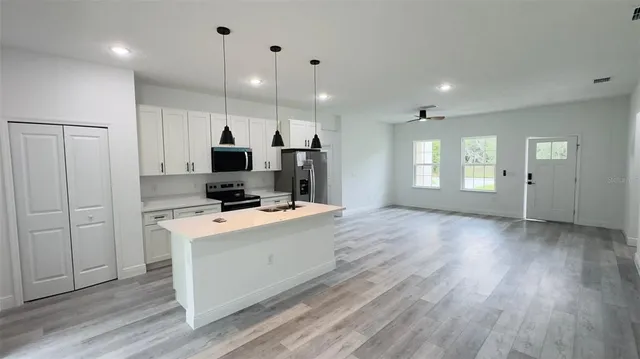 a view of a kitchen cabinets and wooden floor