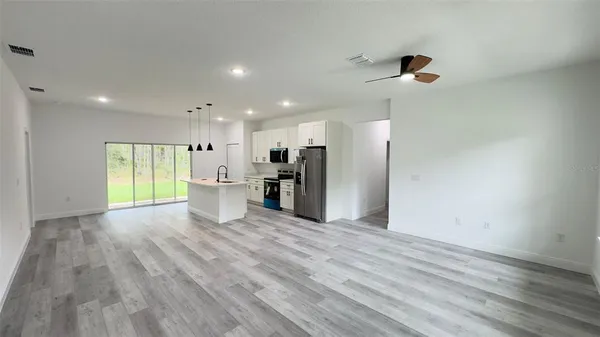 a view of a kitchen with a refrigerator and a window