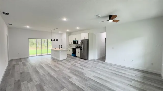 a view of a kitchen with a refrigerator and a window
