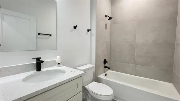 a bathroom with a sink a toilet and a bathtub
