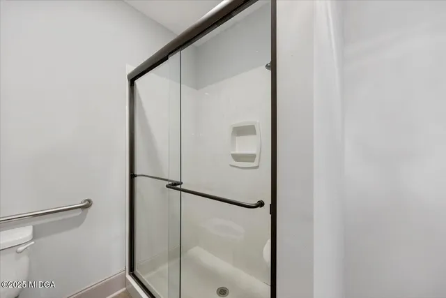 a bathroom with a glass shower door