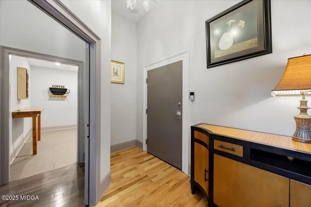 a hallway with front door wooden floor and windows