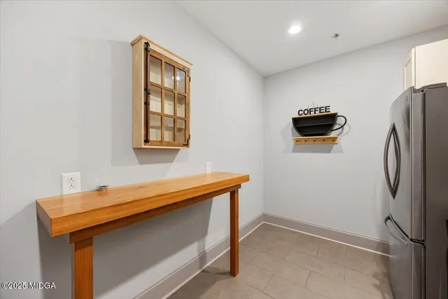 a view of kitchen with stainless steel appliances cabinets and a refrigerator