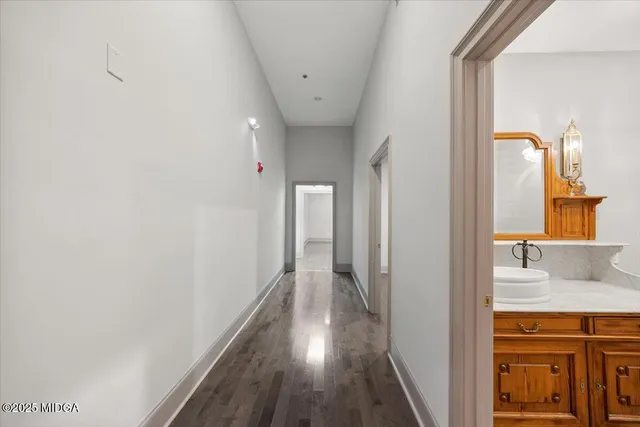 a view of hallway with wooden floor