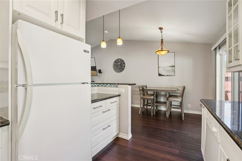 27191 Valleymont Road Lake Forest, CA 92630 - Photo 11 of 37 a kitchen with a refrigerator a sink and wooden floor