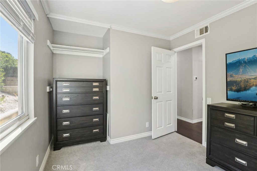 27191 Valleymont Road Lake Forest, CA 92630 - Photo 15 of 37 a room with a dresser with a wooden floor