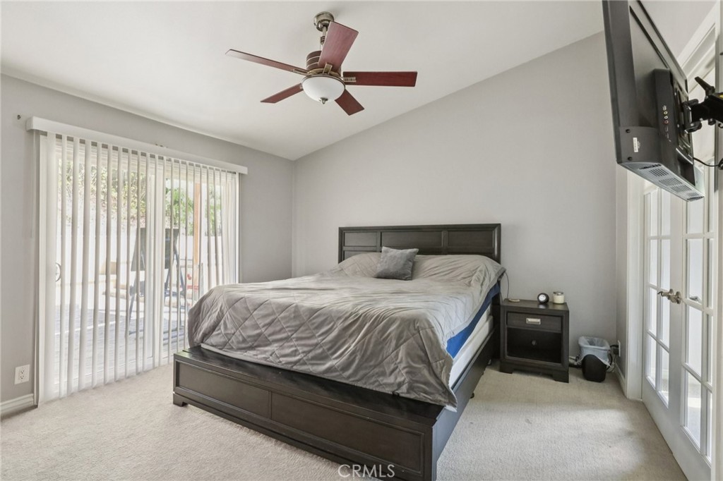 27191 Valleymont Road Lake Forest, CA 92630 - Photo 16 of 37 a bedroom with a bed a flat screen tv and a window