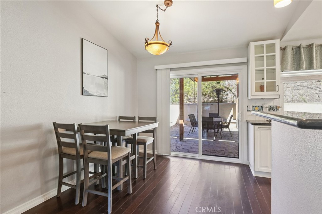 27191 Valleymont Road Lake Forest, CA 92630 - Photo 10 of 37 a dining room with furniture a chandelier and wooden floor