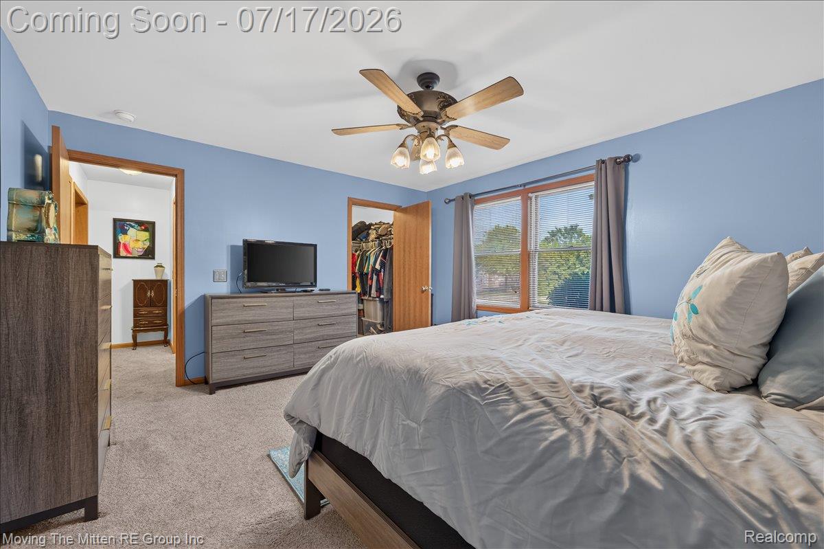 40162 Alden Road Belleville, MI 48111 - Photo 18 of 67 Carpeted room featuring a ceiling fan with light fixture, wood-trimmed window, and a built-in closet with bifold doors