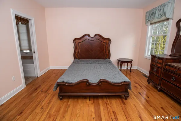 a view of a living room with furniture and wooden floor