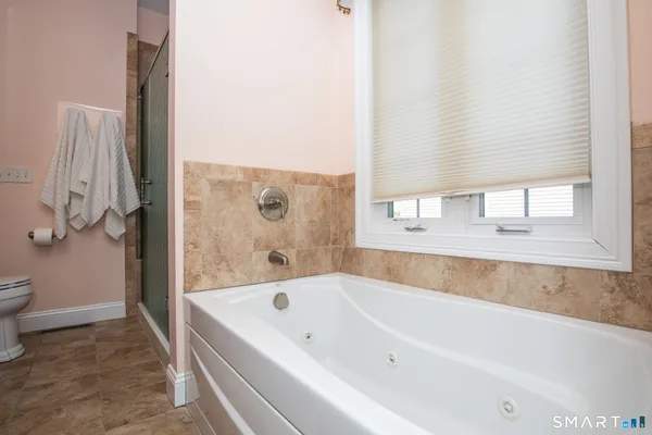 a bathroom with a bathtub and a window