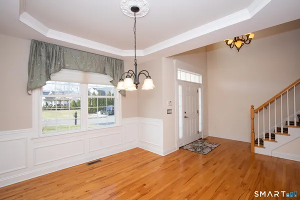 a view of a livingroom with wooden floor and a window